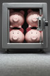 Four piggy banks in safe