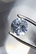 Diamond held by tweezers, close-up