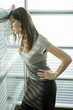 Professional woman looking out window, worried