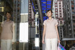 Woman walking past store, looking at window display