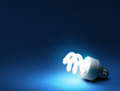 Compact fluorescent bulb - resting on blue background Compact fluorescent bulb - resting on blue background