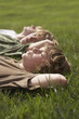 Three teenage brothers 13-17 lying down on front lawn, close up