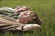 Three teenage brothers 13-17 lying down on grass, close up