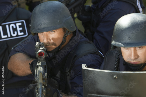 Photo: Swat officers with gun and shield Swat officers with gun and shield