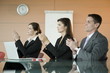 Business people at presentation clapping