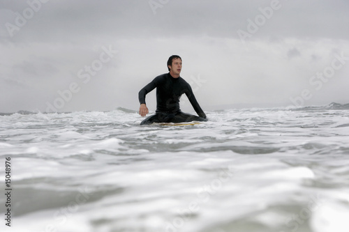 Photo: Young man on surfboard in ocean Young man on surfboard in ocean