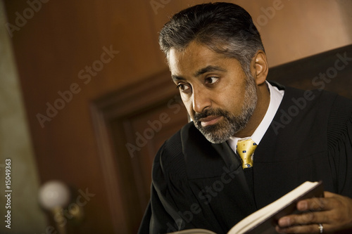 Photo: Middle-aged judge in a courtroom Middle-aged judge in a courtroom