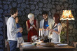 Group of people laughing, standing by dining table
