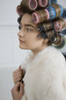 Model in Hair Curlers Wearing Fur Coat