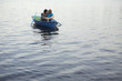 Young Couple Cuddling in Rowboat on Lake