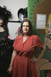 second hand store owner standing by costumes