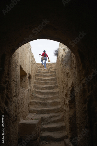 Photo: woman climbing stairs in the tombs of the kings paphos cyprus woman climbing stairs in the tombs of the kings paphos cyprus