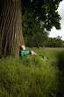woman sitting beneath a tree