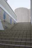 Photo: dubai uae a businessman ascends a staircase leading to deira’s souqs old fortress architecture. dubai uae a businessman ascends a staircase leading to deira’s souqs old fortress architecture.