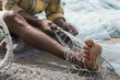 Photo: fujairah uae a local fisherman fixes holes and tangles in his net in fujairah. fujairah uae a local fisherman fixes holes and tangles in his net in fujairah.