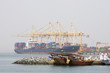 Photo: khor fakkan uae large cargo ships docked to load and unload goods at khor fakkport khor fakkan uae large cargo ships docked to load and unload goods at khor fakkport