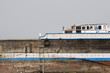 Photo: khor fakkan uae old wooden dhow washed up on shore in front of khor fakkport khor fakkan uae old wooden dhow washed up on shore in front of khor fakkport