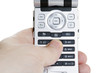 Hand holding a mobile phone and typing a number