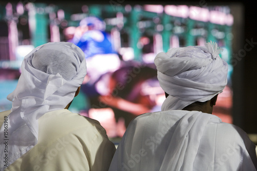 Photo: dubai uae two men traditionally dressed in dishdashs and gutras dubai uae two men traditionally dressed in dishdashs and gutras
