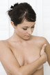 Woman examining breast