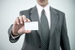 Businessman holding blank business card