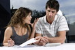 Young couple with check and calculator