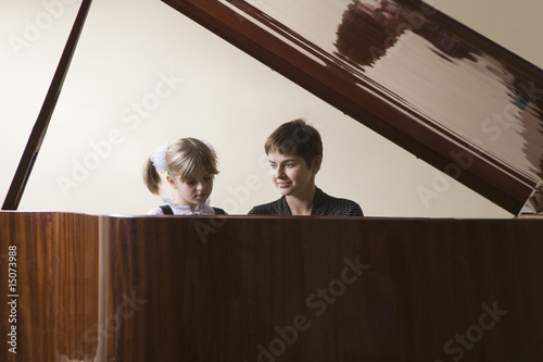 Photo: Female student 5-6 and teacher playing piano Female student 5-6 and teacher playing piano