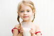 Child drinking a large glass of milk with a milk mustache