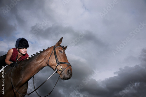 Photo: Female jockey riding horse Female jockey riding horse