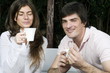 Young couple having breakfast outdoors