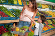 Shopping series - Woman with child buying vegetable