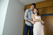 Young couple embracing outside house
