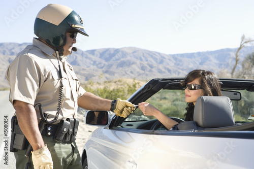 Photo: Highway patrol officer with female driver Highway patrol officer with female driver