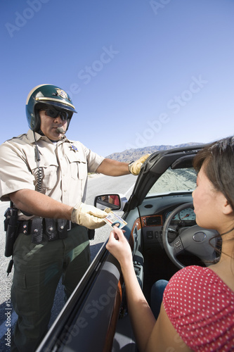 Photo: Police officer checking driver's ID Police officer checking driver's ID