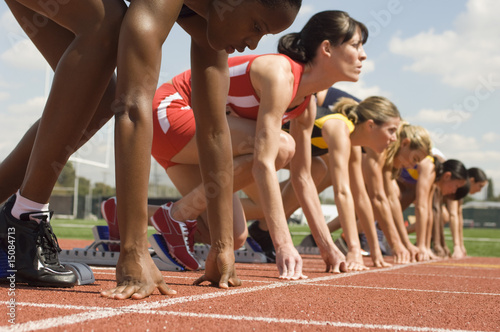 Photo: Group of female track athletes on starting blocks Group of female track athletes on starting blocks