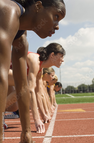 Photo: Group of female track athletes on starting blocks Group of female track athletes on starting blocks