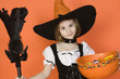 Portrait of girl 7-9 wearing witch costume for Halloween