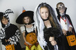 Portrait of boys and girls 7-9 wearing Halloween costumes