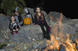 Portrait of boys and girls 7-9 wearing Halloween costumes by campfire