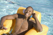 Young Man Listening to Music in Swimming Pool