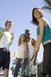 Young Woman Playing Mini Golf with Friends