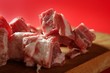 Pig, pork raw meat pieces over red