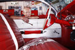 Kent, UK, portrait of mechanic in garage leaning over car window