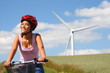 Woman biking / wind turbine