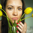 Young charming woman with bouquet of tulips