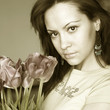 Young charming woman with bouquet of tulips