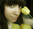 Young charming woman with bouquet of tulips
