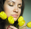 Young charming woman with bouquet of tulips