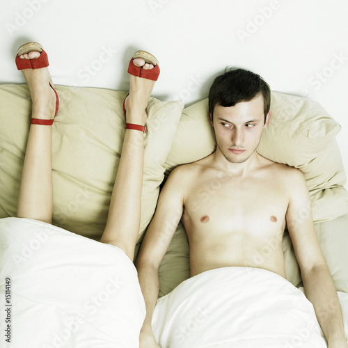 Photo: Portrait of beautiful young lovers in bed Portrait of beautiful young lovers in bed