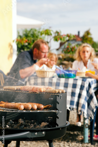 Photo: Family having a barbecue party Family having a barbecue party